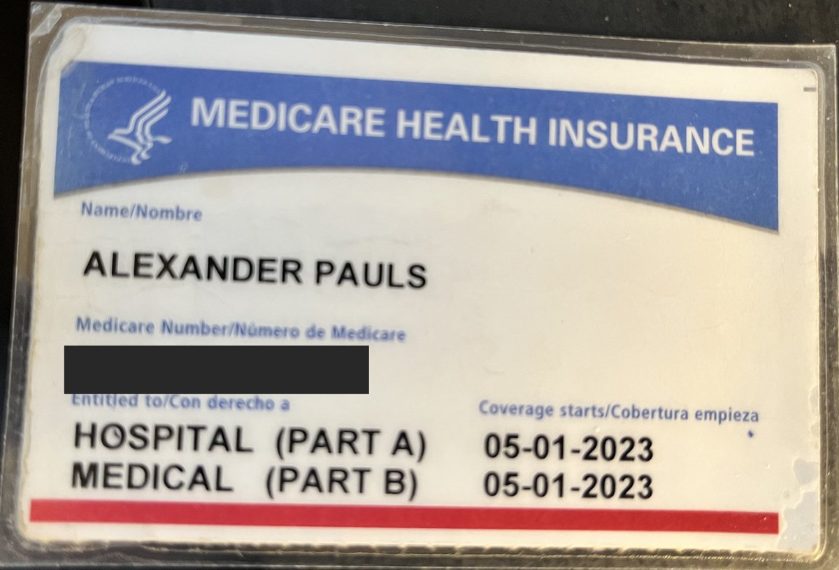 Alex Pauls's own red, white, and blue Medicare card, with the Medicare Number covered for privacy